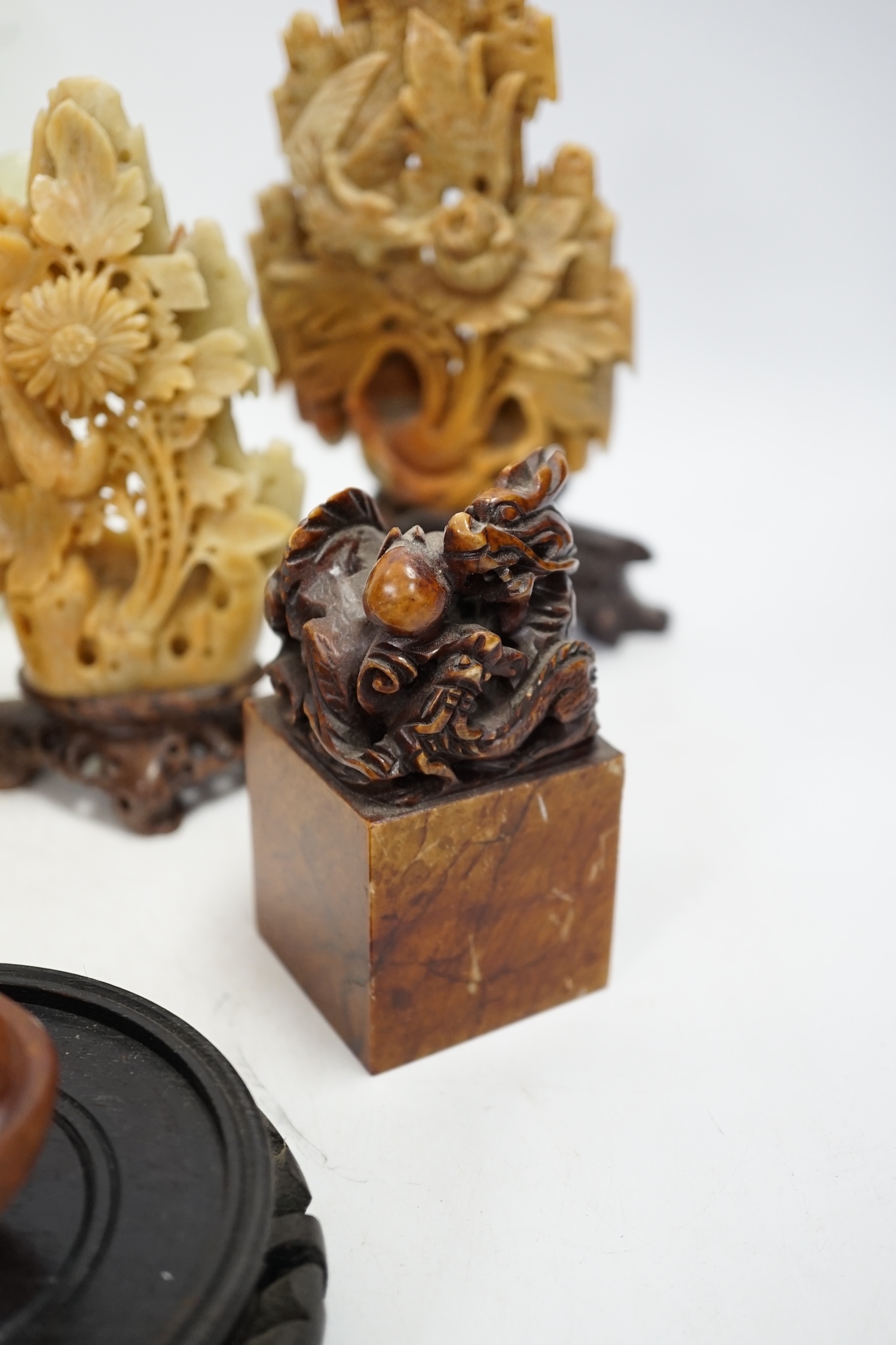 A group of nine Chinese hardstone and soapstone figures, tallest 26cm. Condition - fair